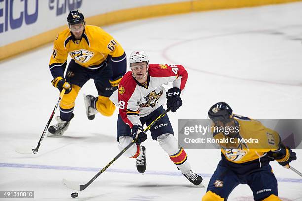 Logan Shaw of the Florida Panthers skates with the puck as Victor Bartley the Nashville Predators chases during a game at Bridgestone Arena on...