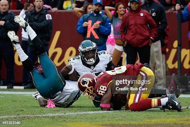 Wide reciever Pierre Garcon of the Washington Redskins catches the game winning touchdown pass in front of Walter Thurmond and Eric Rowe of the...