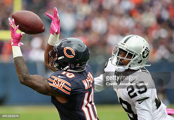 Marquess Wilson of the Chicago Bears hauls in a pass on the last Bears possession of the game in front of David Amerson of the Oakland Raiders at...