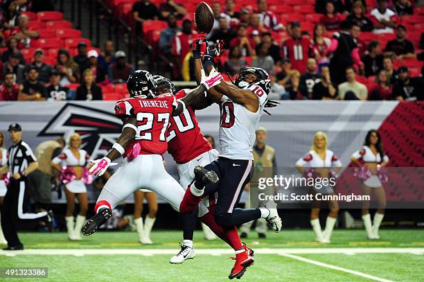 Robenson Therezie and Phillip Adams of the Atlanta Falcons break up a pass intended for DeAndre Hopkins of the Houston Texans in the second half at...