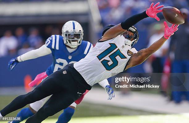 Allen Robinson of the Jacksonville Jaguars reaches for a pass as Darius Butler of the Indianapolis Colts watches at Lucas Oil Stadium on October 4,...