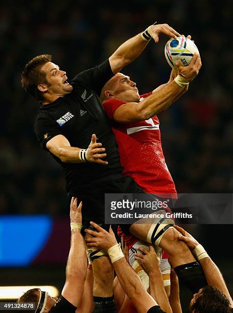 Richie McCaw of New Zealand competes for a line out ball with Lasha Malaguradze of Georgia during the 2015 Rugby World Cup Pool C match between New...