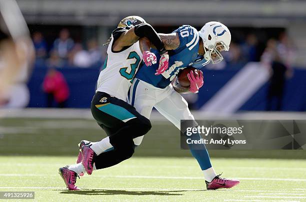 Donte Moncrief of the Indianapolis Colts runs with the ball while defended by Demetrius McCray of the Jacksonville Jaguars during the game at Lucas...