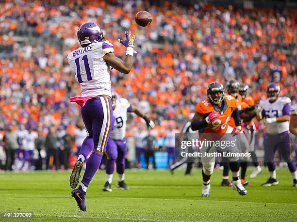 Wide receiver Mike Wallace of the Minnesota Vikings catches a pass for a second quarter touchdown against the Denver Broncos during a game at Sports...