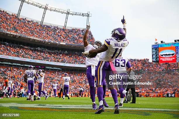 Wide receiver Mike Wallace of the Minnesota Vikings celebrates with quarterback Teddy Bridgewater after the two connected on a pass for a second...