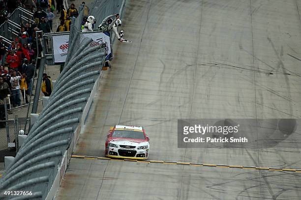 Kevin Harvick, driver of the Budweiser/Jimmy John's Chevrolet, takes the checkered flag to win the NASCAR Sprint Cup Series AAA 400 at Dover...