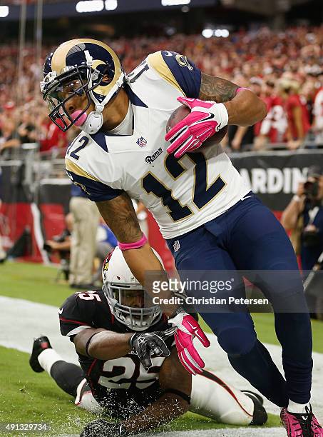 Wide receiver Stedman Bailey of the St. Louis Rams makes a catch for a touchdown while being defended by cornerback Jerraud Powers of the Arizona...