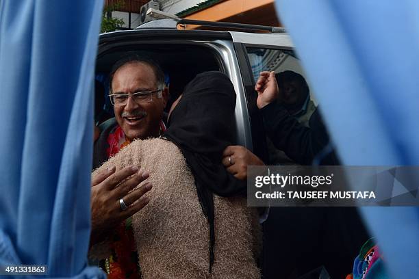 Opposition People's Democratic Party regional candidate for the Srinagar lower house of parliament constituency Tariq Hamid Karra hugs a supporter as...