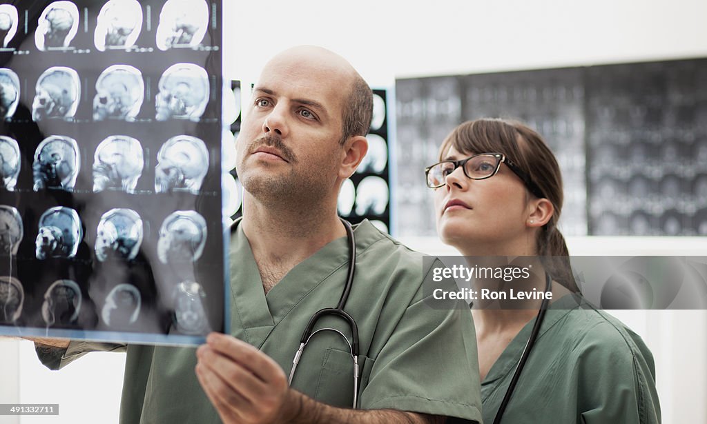 Doctors looking at mri x-rays in hospital
