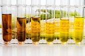 Corn derived ethanol biofuel with test tubes on white background