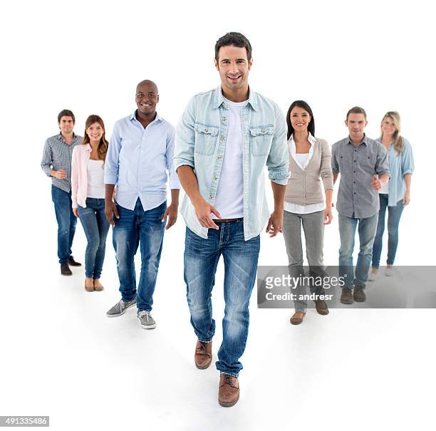 casual man walking and leading a group - medium group of people stock pictures, royalty-free photos & images