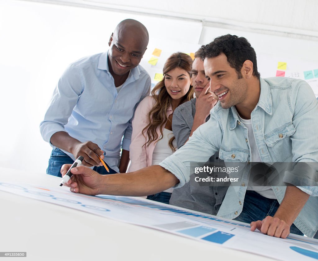 Group of people drawing a business plan