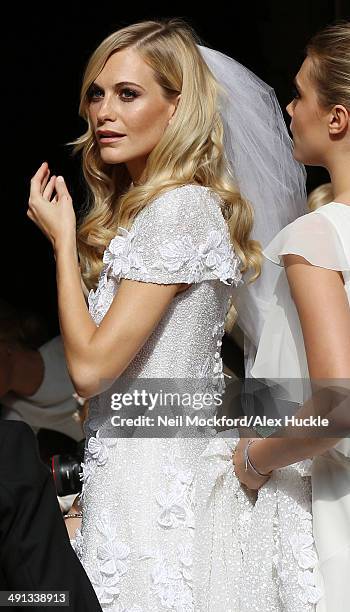 Poppy Delevingne and Cara Delevingne arriving at the wedding of Poppy Delevingne and James Cook on May 16, 2014 in London, England.