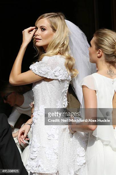 Poppy Delevingne and Cara Delevingne arriving at the wedding of Poppy Delevingne and James Cook on May 16, 2014 in London, England.