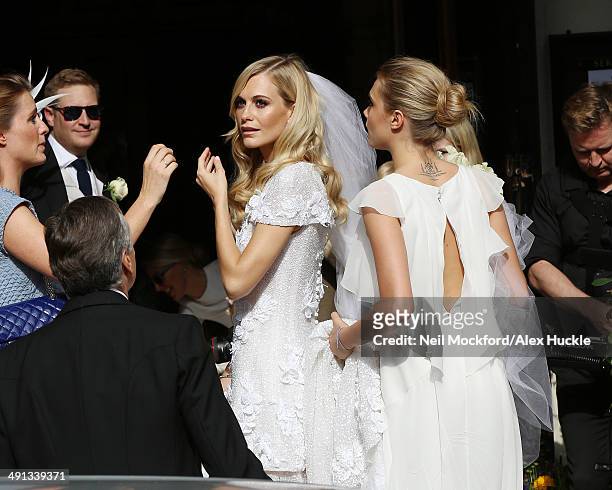 Chloe Delevingne, Charles Delevingne, Poppy Delevingne and Cara Delevingne arriving at the wedding of Poppy Delevingne and James Cook on May 16, 2014...