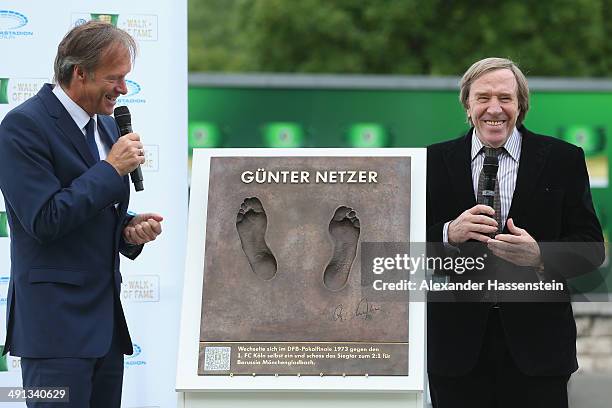 Guenter Netzer talks to the guests during the opening of the DFB Walk of Fame at Olympiastadion Berlin on May 16, 2014 in Berlin, Germany