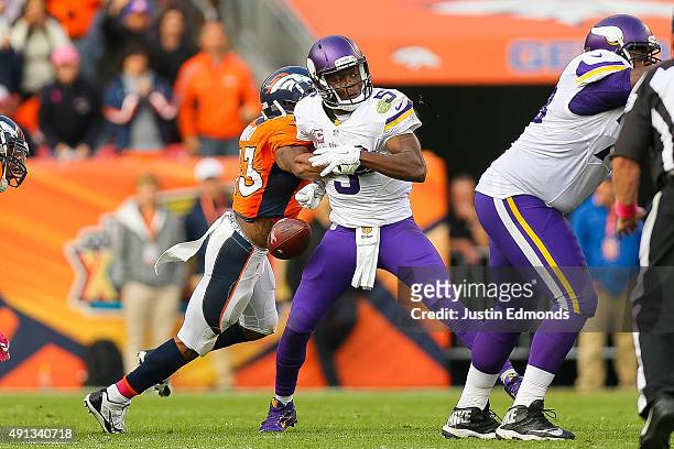 Quarterback Teddy Bridgewater of the Minnesota Vikings has the ball stripped by strong safety T.J. Ward of the Denver Broncos to end the game in...