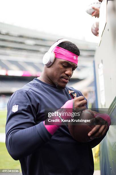 Christian Jones of the Chicago Bears signs autographs prior to the game against the Oakland Raiders at Soldier Field on October 4, 2015 in Chicago,...