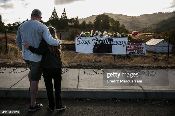 Dave and Robin Griffith, from Portland, stopped by the makeshift memorial to pay their respects after the mass shootings in Umpqua Community College,...