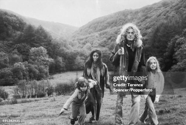 British singer and musician Robert Plant of rock group Led Zeppelin, walks in a field with his family near their home in Machynlleth, Wales on 15th...