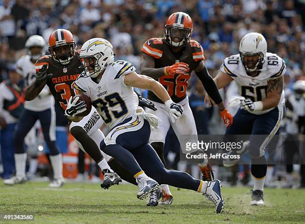 Danny Woodhead of the San Diego Chargers carries the ball, while pursued by Donte Whitner and Christian Kirksey of the Cleveland Browns in the fourth...