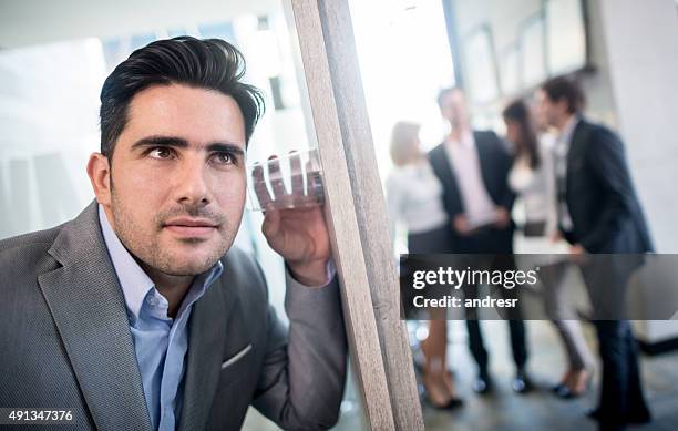 business man spying at the office - breaking through wall stockfoto's en -beelden