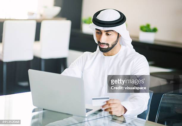 middle eastern man shopping online - west asia stock pictures, royalty-free photos & images