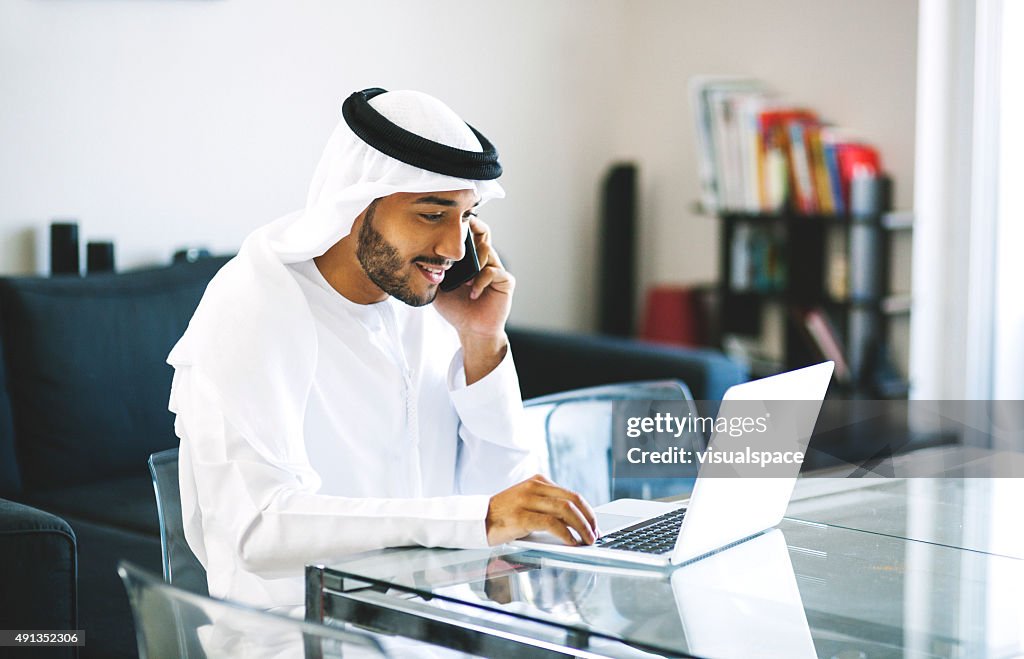 Young Arab Man on Phone while Browsing