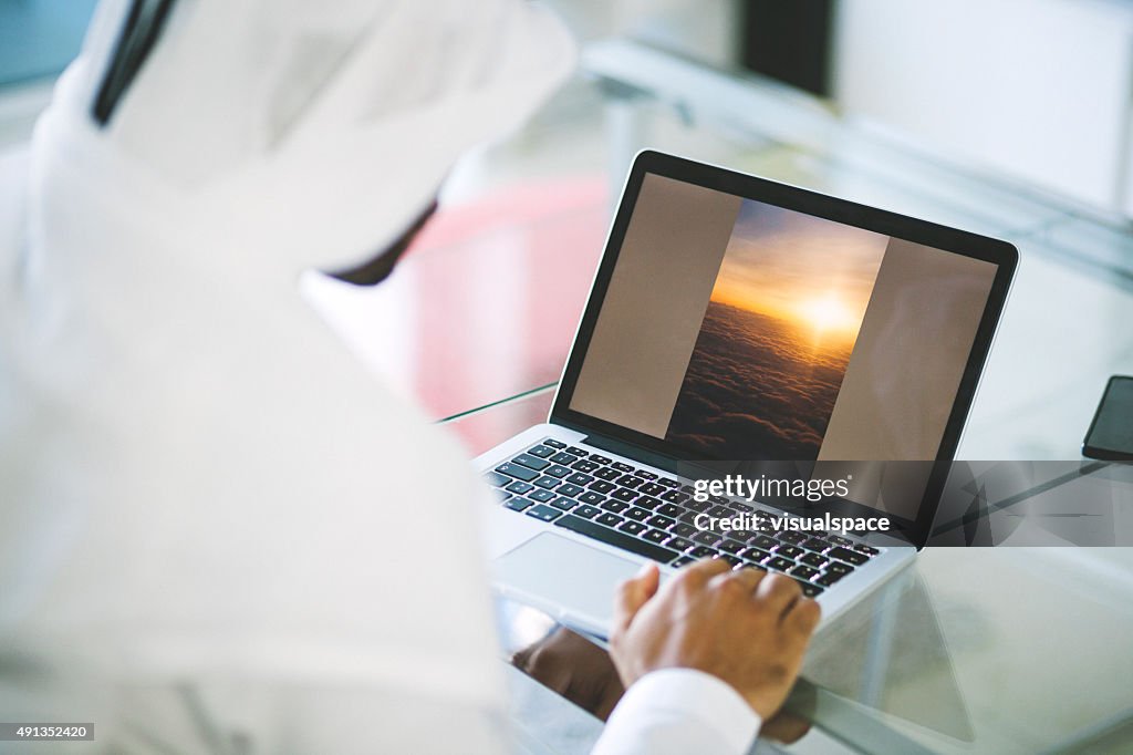 Emirati Man Using Laptop at Home