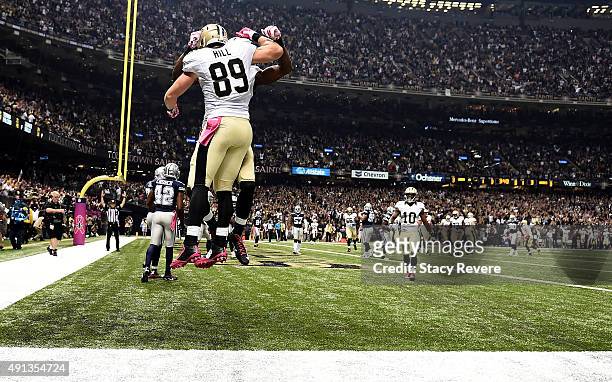 Josh Hill of the New Orleans Saints scores a touchdown after receiving a pass from Drew Brees of the New Orleans Saints during the first quarter...