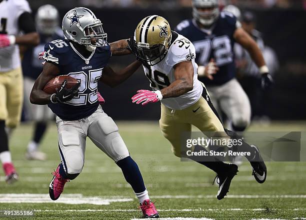 Lance Dunbar of the Dallas Cowboys defends against Kenny Phillips of the New Orleans Saints during the first quarter against the Dallas Cowboys at...