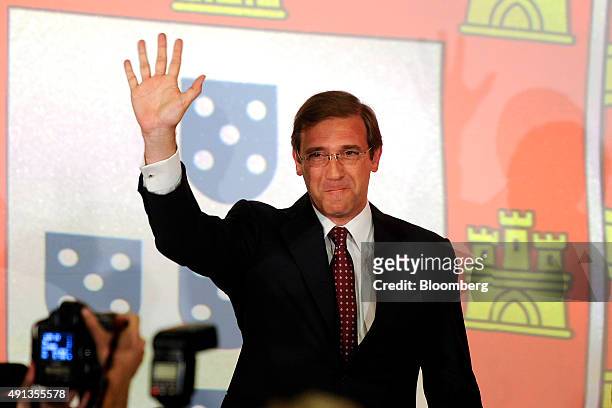 Pedro Passos Coelho, Portugal's prime minister and leader of the Social Democratic Party , waves to supporters after securing victory in the...