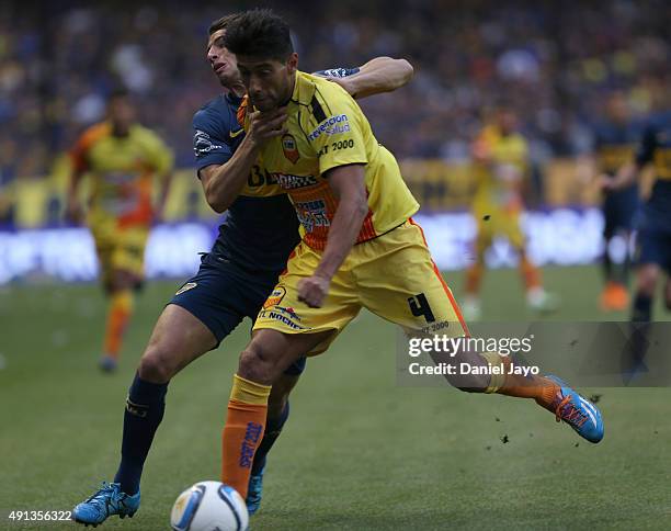Jonathan Calleri, of Boca Juniors, and Julio Barraza, of Crucero del Norte, fight for the ball during a match between Boca Juniors and Crucero del...