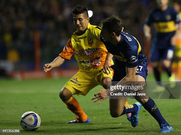 Maximiliano Oliva, of Crucero del Norte, and Jonathan Calleri, of Boca Juniors, vie for the ball during a match between Boca Juniors and Crucero del...