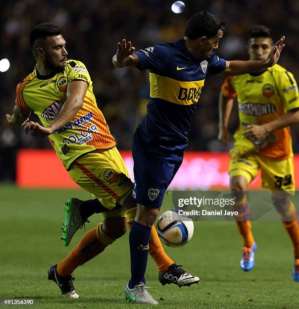 Maximiliano Oliva, of Crucero del Norte, and Carlos Tevez, of Boca Juniors, fight for the ball during a match between Boca Juniors and Crucero del...