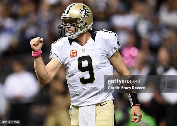 Drew Brees of the New Orleans Saints reacts after the Saints score a touchdown during the fourth quarter against the Dallas Cowboys at Mercedes-Benz...