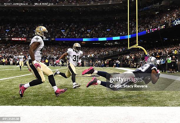 Terrance Williams of the Dallas Cowboys scores a touchdown during the fourth quarter against the New Orleans Saints at Mercedes-Benz Superdome on...