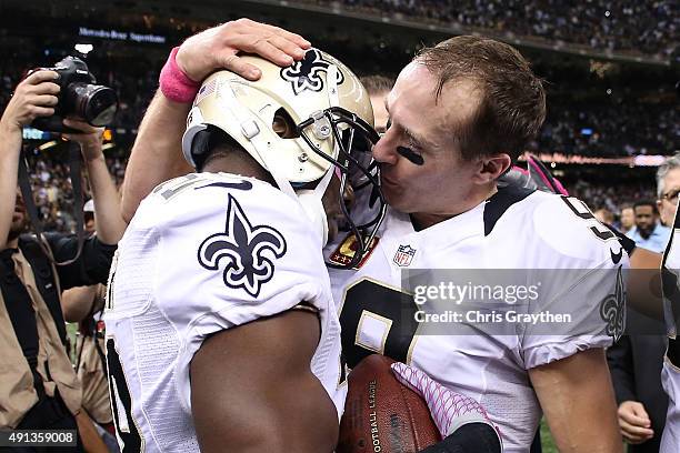 Spiller hands Drew Brees of the New Orleans Saints the ball after scoring a touchdown on Brees' 400th Touchdown Pass at Mercedes-Benz Superdome on...