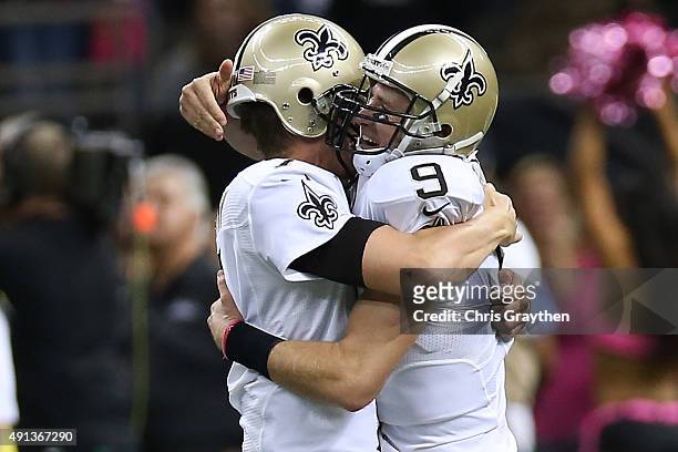 Drew Brees of the New Orleans Saints celebrates after throwing his 400th touchdown pass to C.J. Spiller of the New Orleans Saints in overtime to...