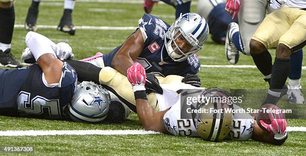 Dallas Cowboys inside linebacker Damien Wilson and Dallas Cowboys strong safety Barry Church can't keep New Orleans Saints running back Mark Ingram...