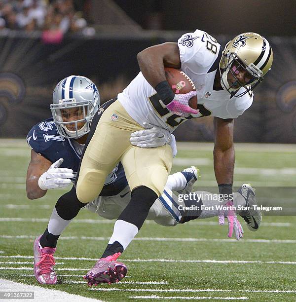 Dallas Cowboys inside linebacker Damien Wilson hits New Orleans Saints running back C.J. Spiller on Sunday, Oct. 4 at the Mercedes-Benz Superdome in...