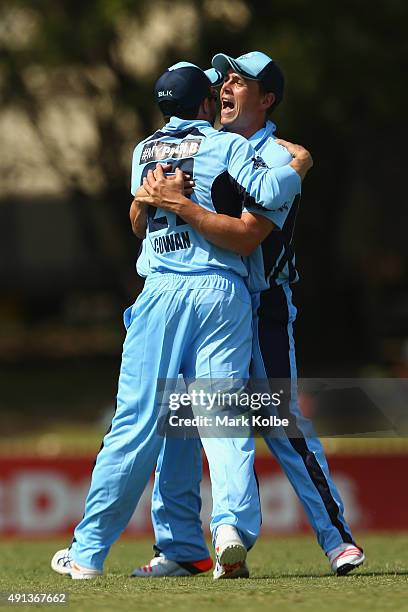 Steve O'Keefe and Ed Cowan of the Blues celebrate after Cowan took the catch to remove William Bosisto of the Cricket Australia XI during the Matador...