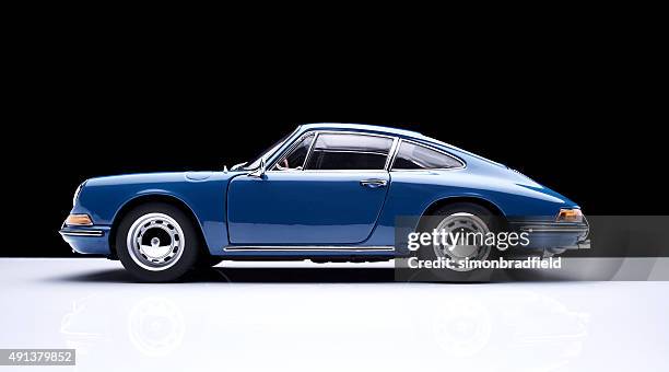 porsche 911 model car against black - porsche stockfoto's en -beelden