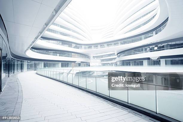 empty corridor in the modern office building - mall inside stock pictures, royalty-free photos & images