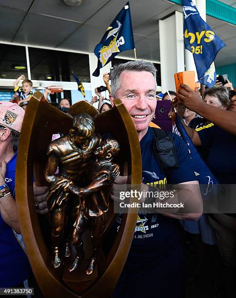 Cowboys coach Paul Green holds the NRL trophy after arriving back at the Townsville airport before heading out to the North Queensland Cowboys NRL...