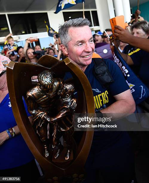 Cowboys coach Paul Green holds the NRL trophy after arriving back at the Townsville airport before heading out to the North Queensland Cowboys NRL...