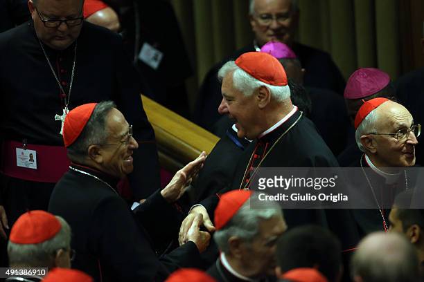Cardinal Oscar Rodriguez Maradiaga and Cardinal Gerhard Ludwig Muller chat prior to the opening session of the Synod on the themes of family at Synod...