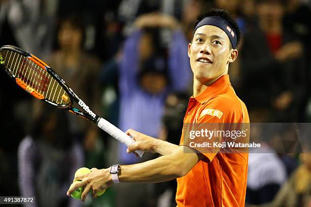 Kei Nishikori of Japan hits the balls into the audience after winning the men's singles first round match against Borna Coric of Croatia on day one...