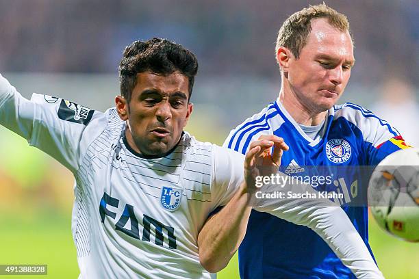 Patrick Kohlmann of Holstein Kiel challenges Ahmed Waseem Razeek of 1. FC Magdeburg during the 3. League match between Holstein Kiel and 1. FC...