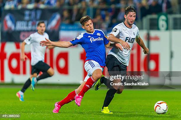 Marius Sowislo of 1. FC Magdeburg challenges Tim Siedschlag of Holstein Kiel during the 3. League match between Holstein Kiel and 1. FC Magdeburg at...